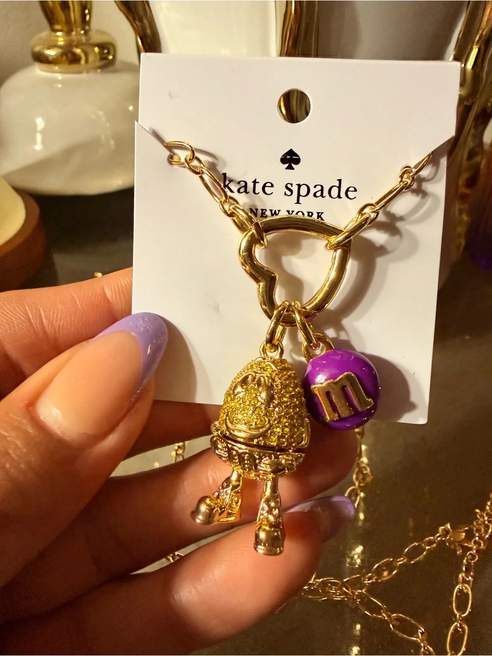 kate spade Gold Tone Necklace with Purple M&M Charm